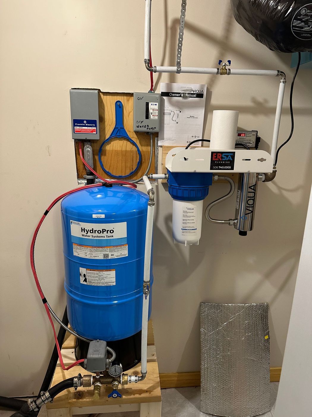 Well pressure tank and water treatment system installation